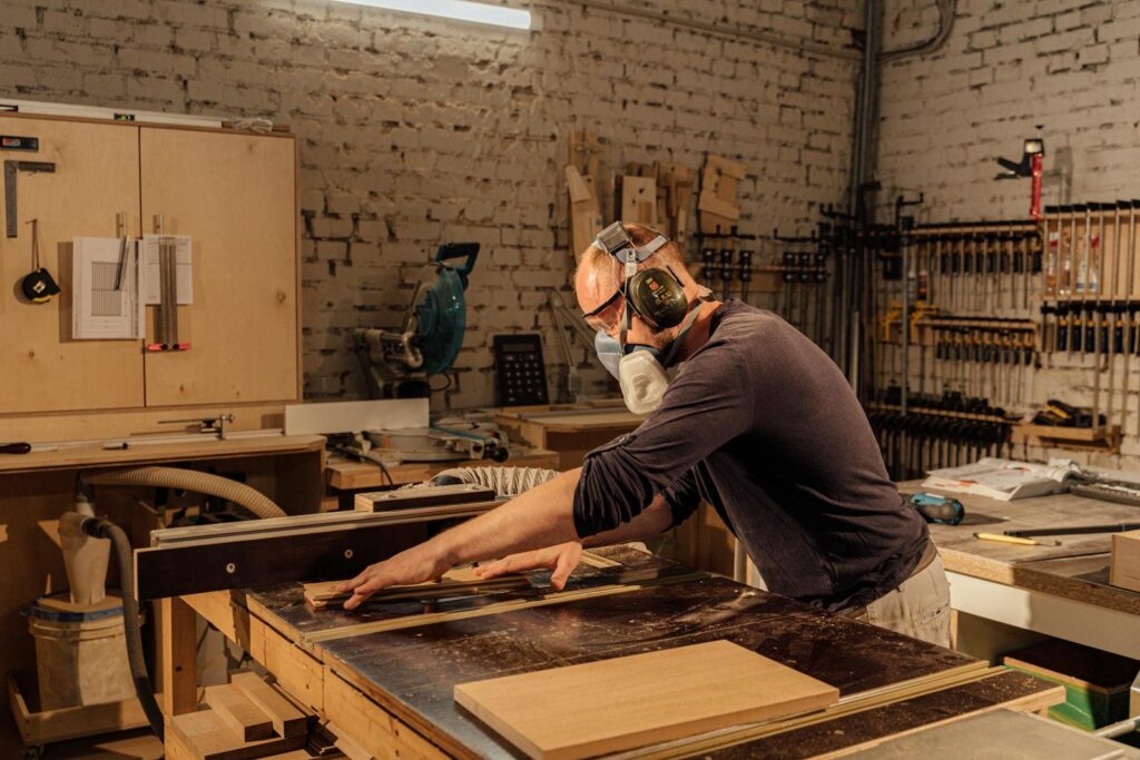 A Man in Black Long Sleeve Shirt Doing Woodworks
